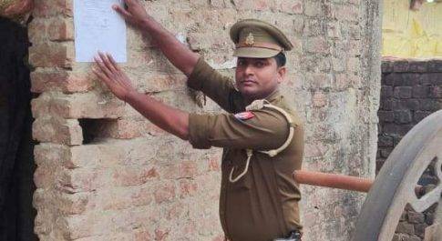 बृजमनगंज पुलिस ने वांछित अभियुक्त की तलाश में किया चस्पा नोटिस